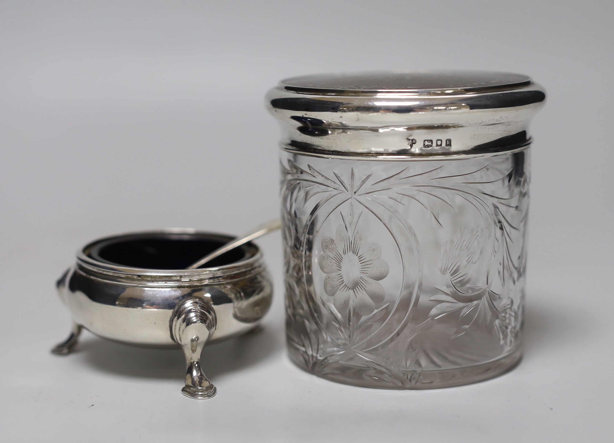A George V silver and tortoiseshell pique lidded glass toilet jar, Charles & Richard Comyns, London, 1925, height 89mm, a silver mounted capstan inkwell and a silver salt and plated condiment spoon.